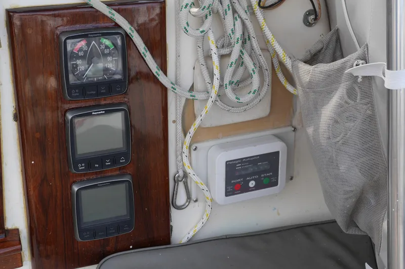 Slide: The Image of Propane tank setup on 1976 Westsail 32 sailboat, featuring ropes and metal fittings. - 22