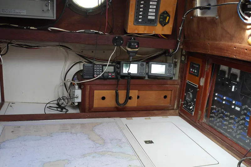 Slide: The Image of Compass and ropes on 1976 Westsail 32 sailboat deck, featuring wooden trim. - 28