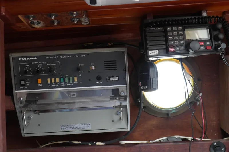 Slide: The Image of 1976 Westsail 32 sailboat cockpit with polished wood hatch and secured lock. - 32