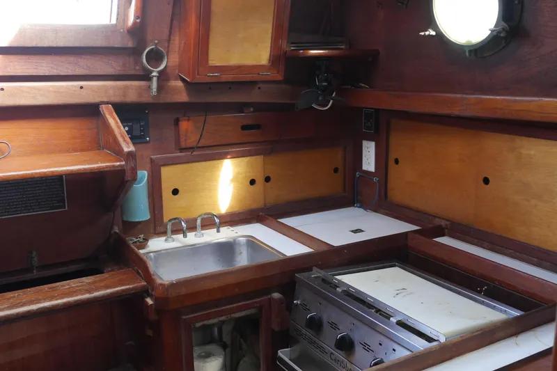 Slide: The Image of 1976 Westsail 32 sailboat cockpit with wooden trim and nautical equipment. - 33