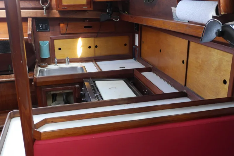 Slide: The Image of 1976 Westsail 32 sailboat deck view, docked at marina, showcasing rigging and railings. - 34