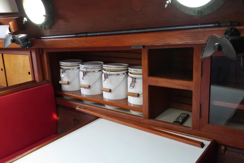 Slide: The Image of Navigation station of a 1976 Westsail 32 sailboat with communication equipment and nautical chart. - 35