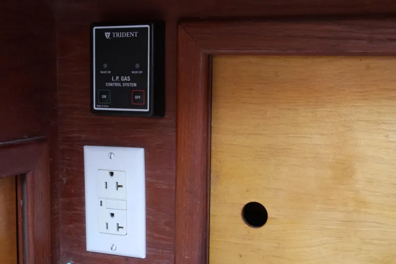 Slide: The Image of L.P. gas control system and electrical outlet on 1976 Westsail 32 boat interior. - 42
