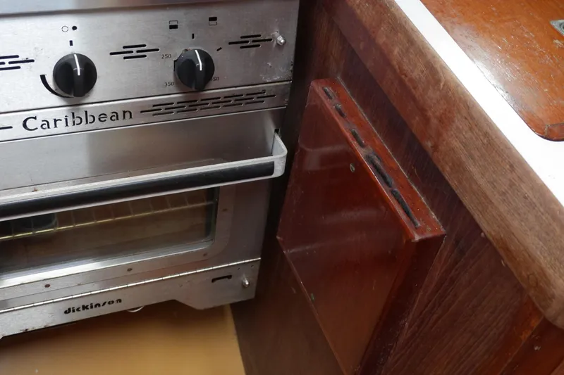 Slide: The Image of 1976 Westsail 32 yacht galley with Caribbean stove and wooden cabinetry. - 45