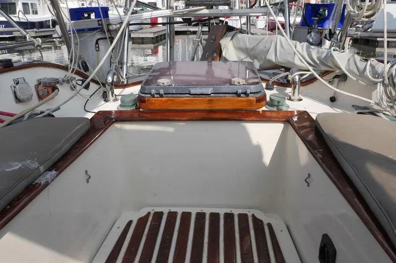 Slide: The Image of 1976 Westsail 32 interior storage compartment with white container. - 46