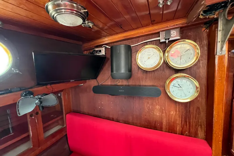 Slide: The Image of Interior of 1976 Westsail 32 sailboat with red seating and nautical instruments. - 50