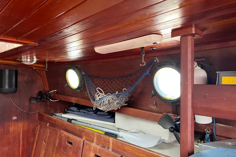 Slide: The Image of Interior of 1976 Westsail 32 sailboat with instruments, TV, and red seating. - 55