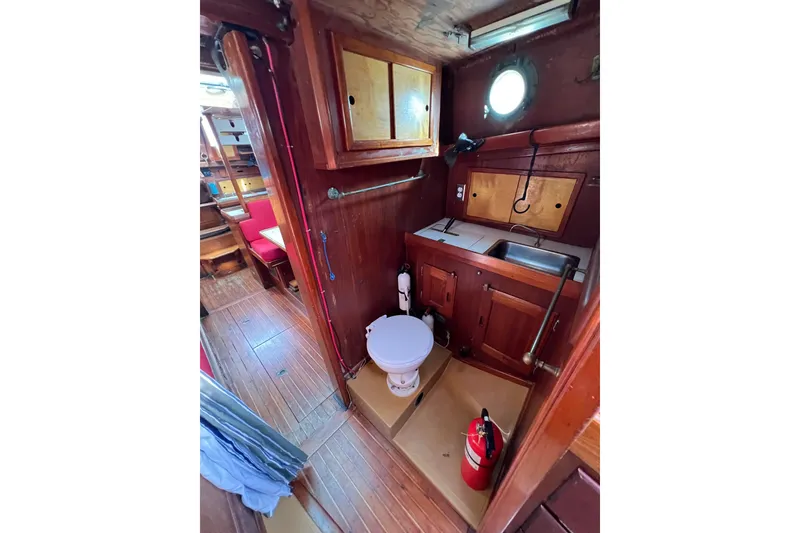 Slide: The Image of Interior of a 1976 Westsail 32 sailboat with wooden paneling and portholes. - 59