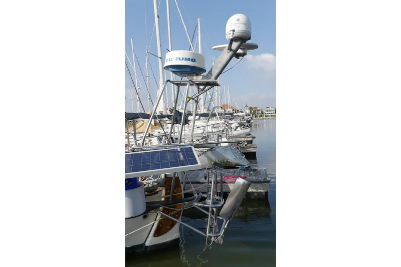 Slide: The Image of 1976 Westsail 32 sailboat deck with rigging and winches in a marina. - 9