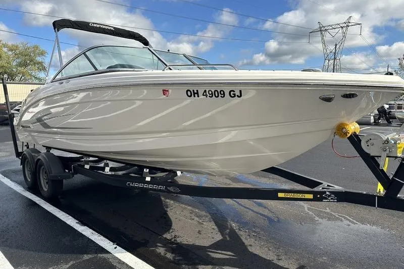 Slide: The Image of 2022 Chaparral 23 SSi boat on trailer, parked outdoors under blue sky. - 10