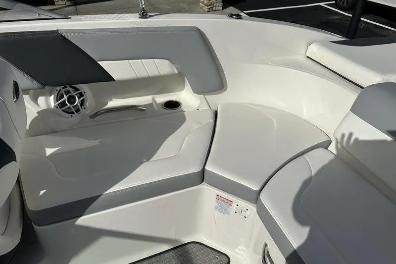 Slide: The Image of 2022 Chaparral 23 SSi boat interior with white seating and speaker detail. - 12