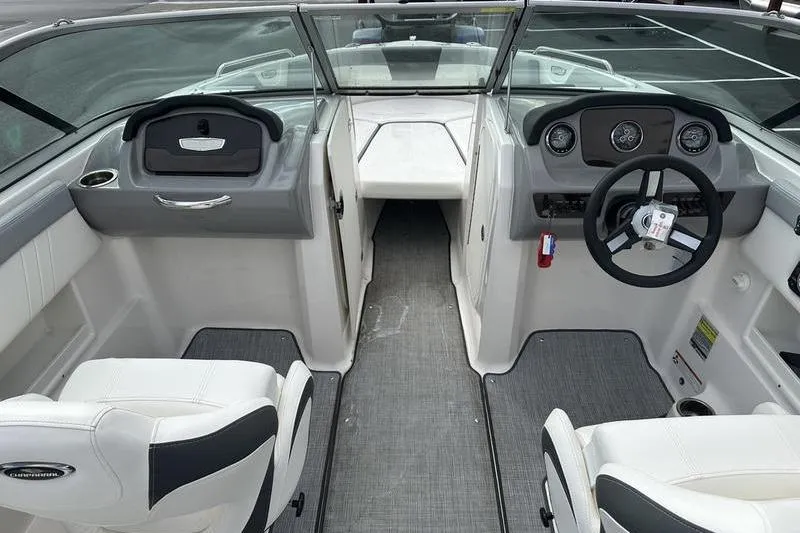 Slide: The Image of 2022 Chaparral 23 SSi boat interior with steering wheel and seating area. - 22