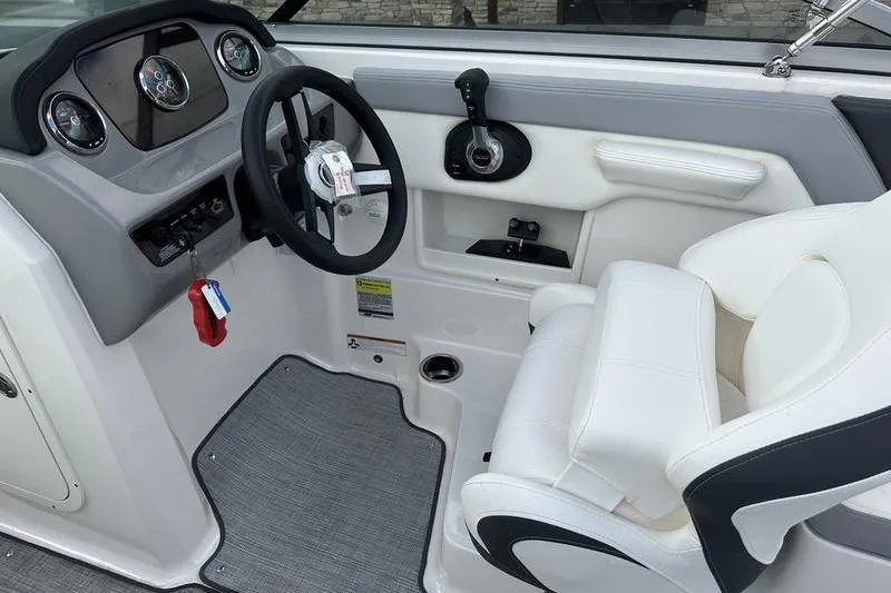 Slide: The Image of 2022 Chaparral 23 SSi boat interior with steering wheel and control panel. - 25