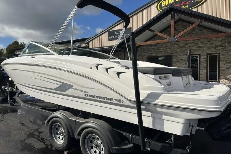 Slide: The Image of 2022 Chaparral 23 SSi boat on trailer outside dealership, showcasing sleek design. - 3