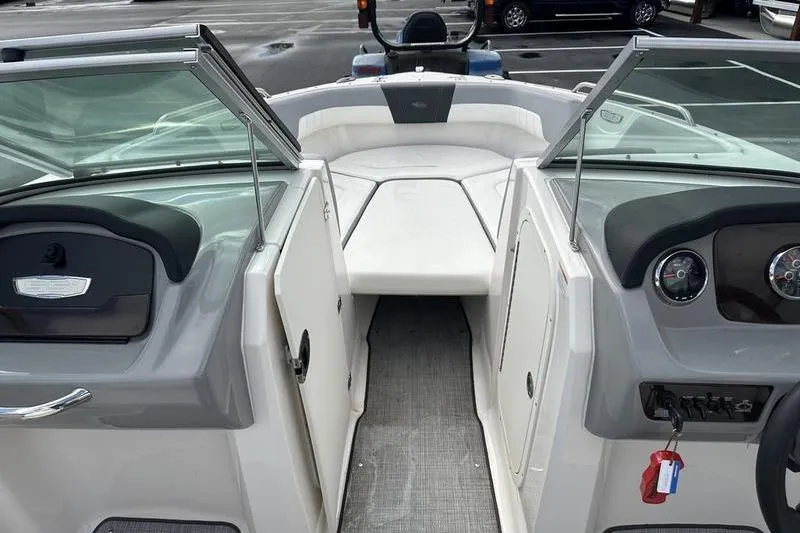 Slide: The Image of 2022 Chaparral 23 SSi boat interior with open bow seating and dashboard view. - 30