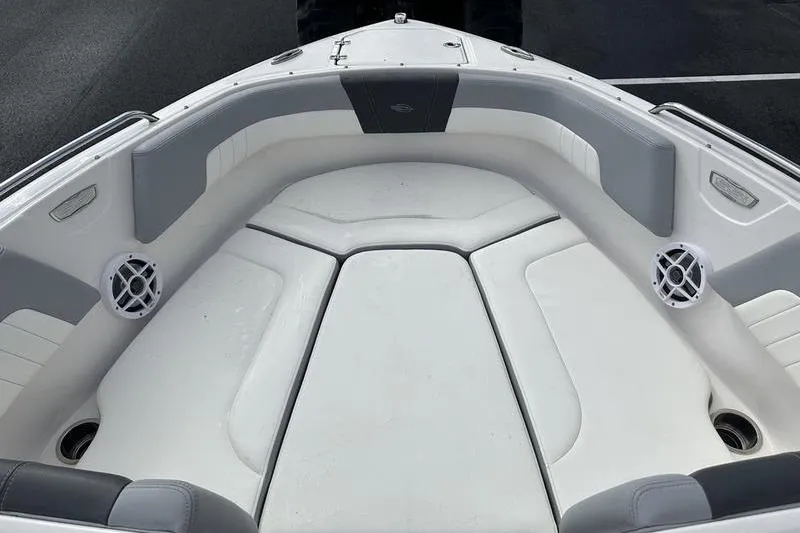 Slide: The Image of 2022 Chaparral 23 SSi boat interior with cushioned seating and speakers. - 32
