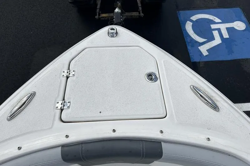 Slide: The Image of Bow of 2022 Chaparral 23 SSi boat near a handicap parking space. - 33