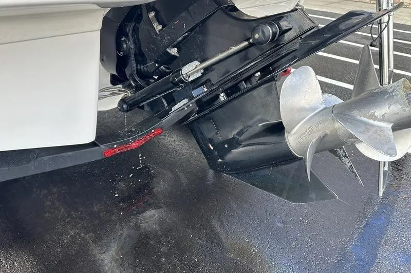 Slide: The Image of Close-up of 2022 Chaparral 23 SSi boat propeller and outdrive on wet pavement. - 5