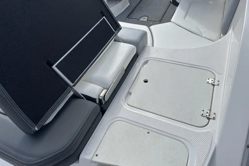 Slide: The Image of 2022 Chaparral 23 SSi boat interior with storage compartments and seating. - 7