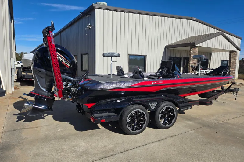 Slide: The Image of 2022 Skeeter FXR20 Apex boat with trailer, parked outside a building. - 1