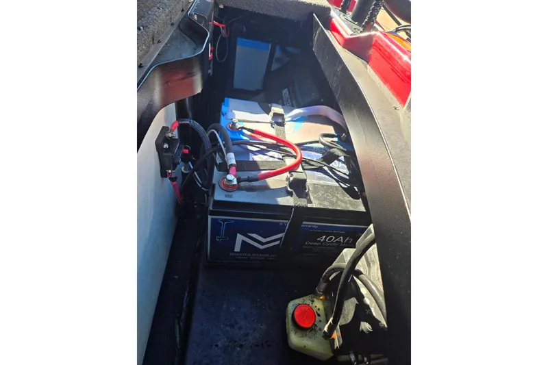 Slide: The Image of Battery compartment of 2022 Skeeter FXR20 Apex boat, featuring a 40Ah deep cycle battery. - 11