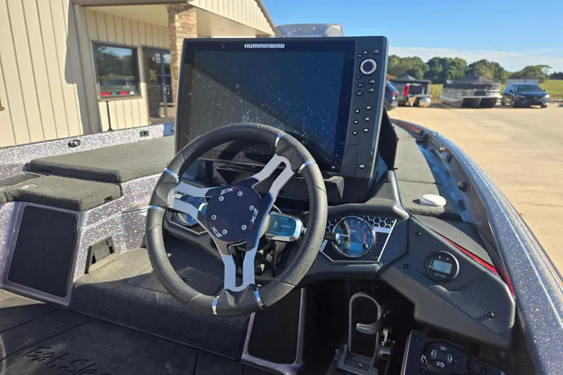 Slide: The Image of 2022 Skeeter FXR20 Apex boat dashboard with steering wheel and Humminbird display. - 13