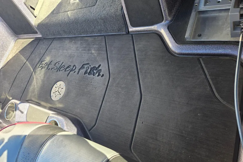 Slide: The Image of 2022 Skeeter FXR20 Apex boat interior with "Eat. Sleep. Fish." text on floor mat. - 5