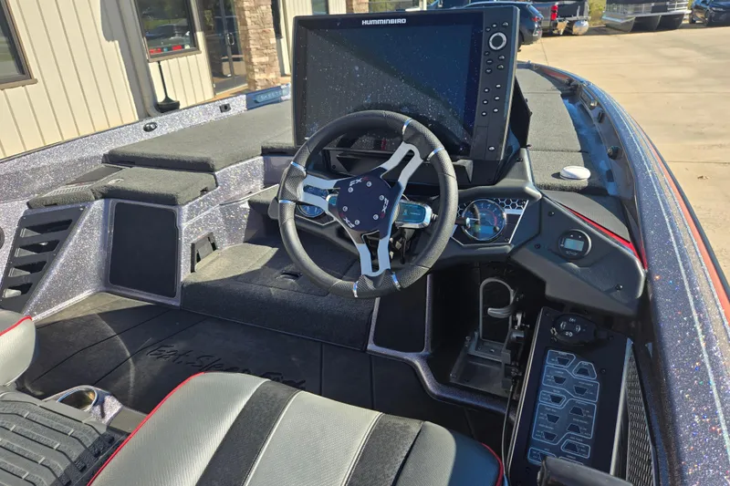 Slide: The Image of 2022 Skeeter FXR20 Apex boat cockpit with steering wheel and advanced navigation system. - 7