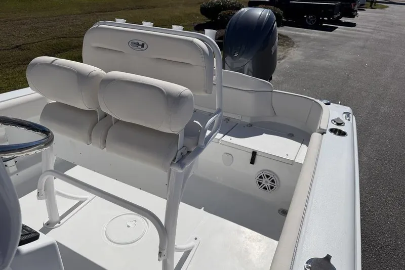 Slide: The Image of 2026 Sea Hunt Ultra 219 boat interior with cushioned seating and steering wheel. - 13