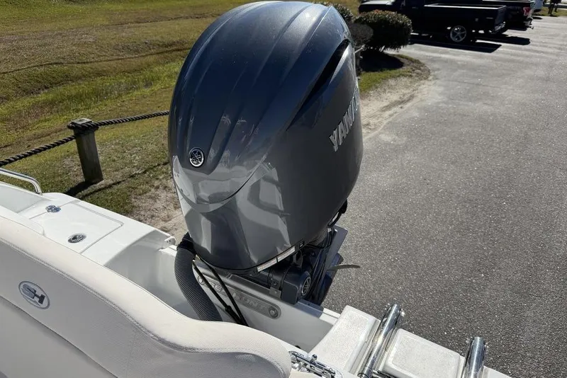 Slide: The Image of 2026 Sea Hunt Ultra 219 boat with Yamaha outboard motor in a parking area. - 9