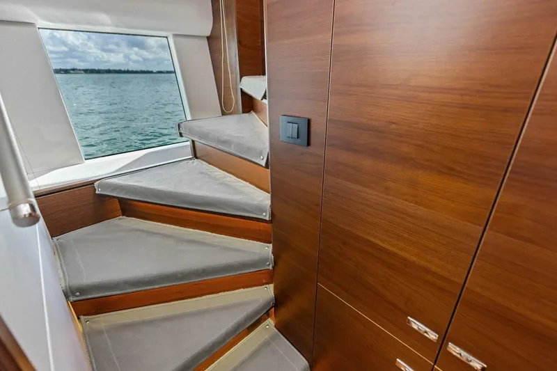 Slide: The Image of Staircase with wooden finish inside 2018 Princess Y75 yacht, overlooking ocean view. - 24