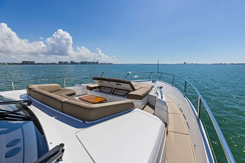 Slide: The Image of Luxurious 2018 Princess Y75 yacht deck with seating, overlooking serene ocean and skyline. - 55