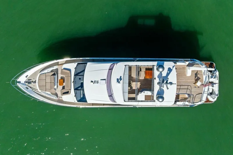Slide: The Image of Aerial view of 2018 Princess Y75 yacht on green water. - 68