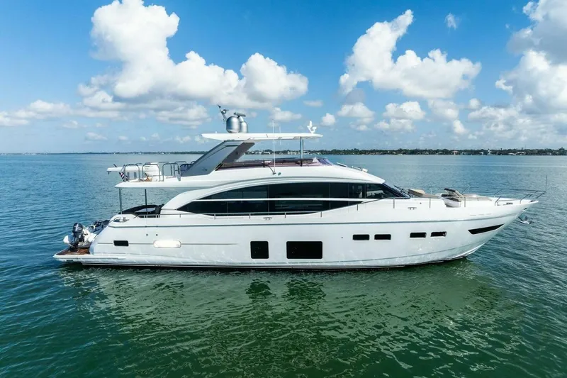 Slide: The Image of Luxurious 2018 Princess Y75 yacht cruising on calm waters under a clear blue sky. - 69