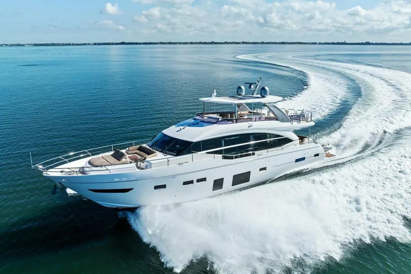 Slide: The Image of Luxurious 2018 Princess Y75 yacht cruising on open water, creating elegant waves. - 79