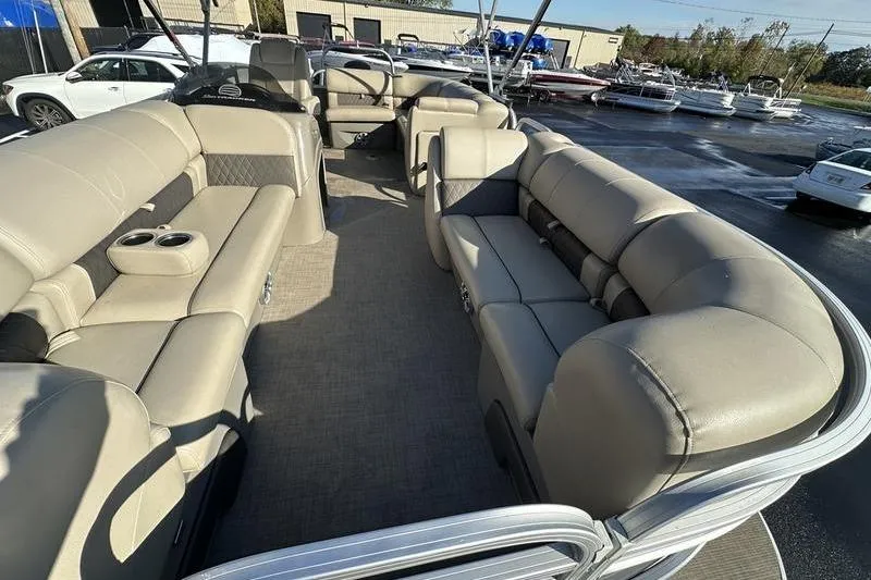 Slide: The Image of 2023 Sun Tracker Party Barge 20 DLX interior with spacious seating and cup holders. - 10