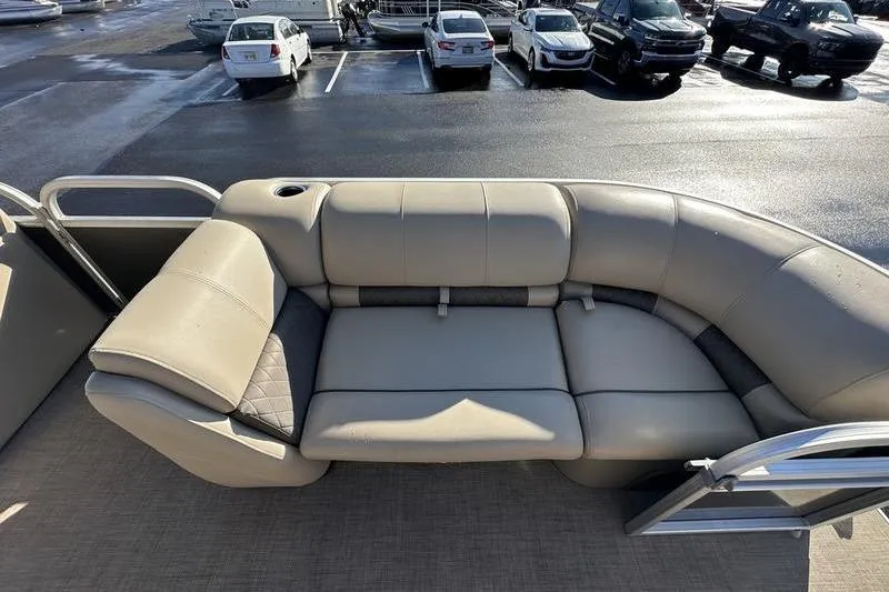 Slide: The Image of 2023 Sun Tracker Party Barge 20 DLX pontoon seating area in a parking lot. - 16