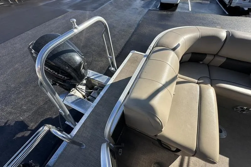 Slide: The Image of 2023 Sun Tracker Party Barge 20 DLX with beige seating and outboard motor. - 24