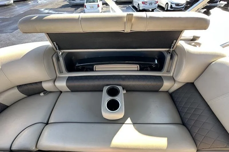 Slide: The Image of 2023 Sun Tracker Party Barge 20 DLX interior with storage and cup holders. - 26
