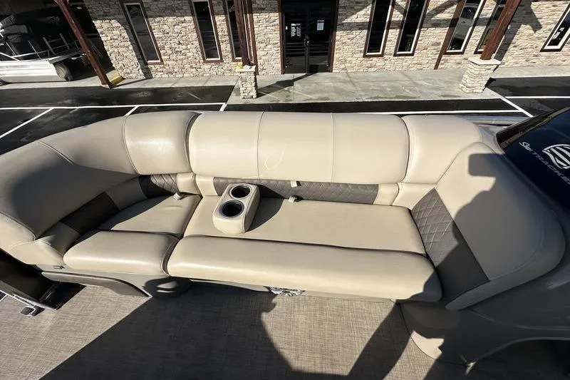 Slide: The Image of 2023 Sun Tracker Party Barge 20 DLX with beige seating and cup holders. - 6
