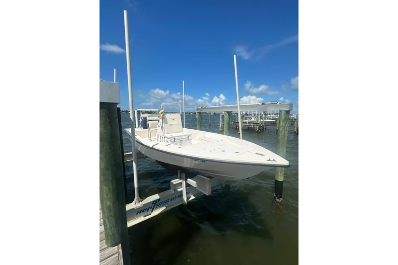 The Image of 2005 Pathfinder 2200 V Tournament Edition boat on lift, clear sky, waterfront view. - 0