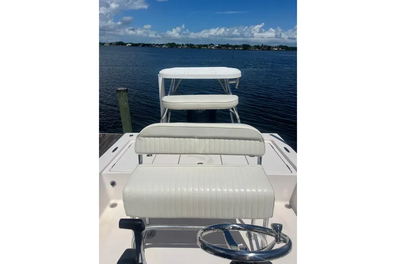 Slide: The Image of 2005 Pathfinder 2200 V Tournament Edition boat interior with seating, overlooking calm waters. - 11