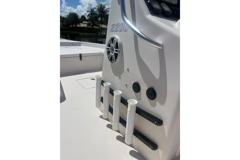 Slide: The Image of 2005 Pathfinder 2200 V Tournament Edition boat console with rod holders and speaker. - 12
