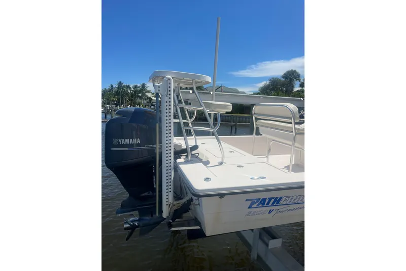 Slide: The Image of 2005 Pathfinder 2200 V Tournament Edition boat with Yamaha outboard motor, docked by palm trees. - 14