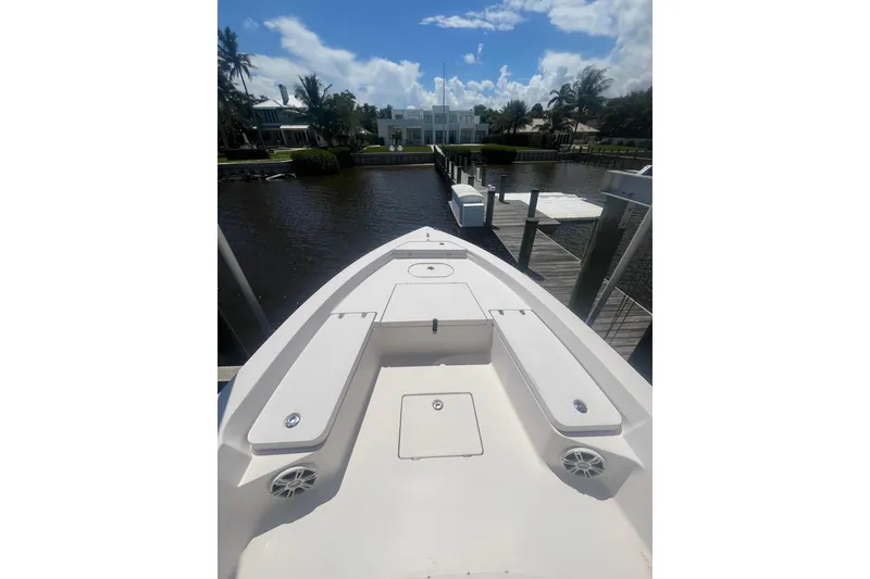 Slide: The Image of 2005 Pathfinder 2200 V Tournament Edition boat docked by a scenic waterfront. - 2