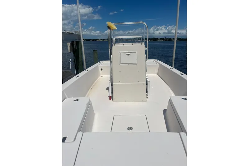 Slide: The Image of 2005 Pathfinder 2200 V Tournament Edition boat interior with console, docked by the water. - 4