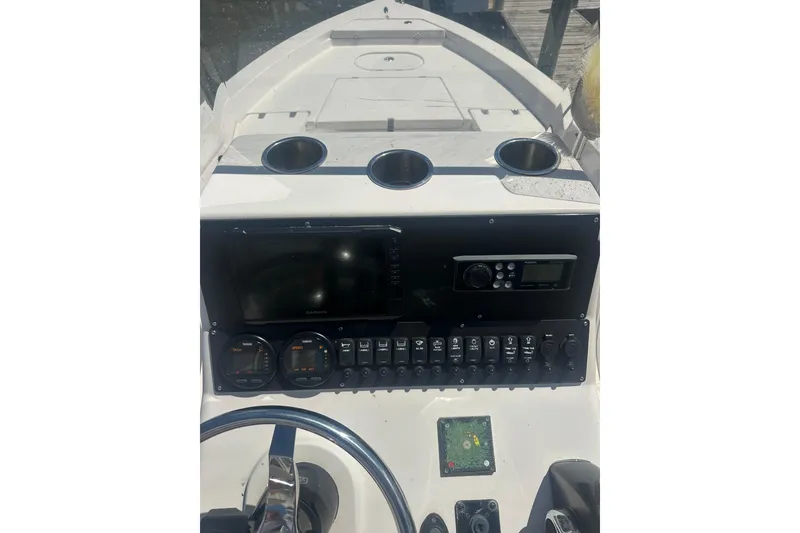 Slide: The Image of 2005 Pathfinder 2200 V Tournament Edition boat dashboard with gauges and controls. - 7