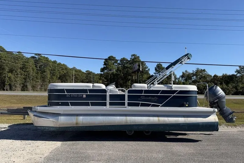 The Image of 2018 Godfrey SWEETWATER 2286 SB pontoon boat on trailer, parked outdoors. - 1