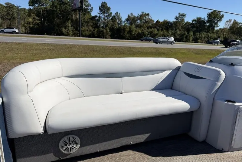 Slide: The Image of White seating on 2018 Godfrey SWEETWATER 2286 SB boat, parked near a road. - 10