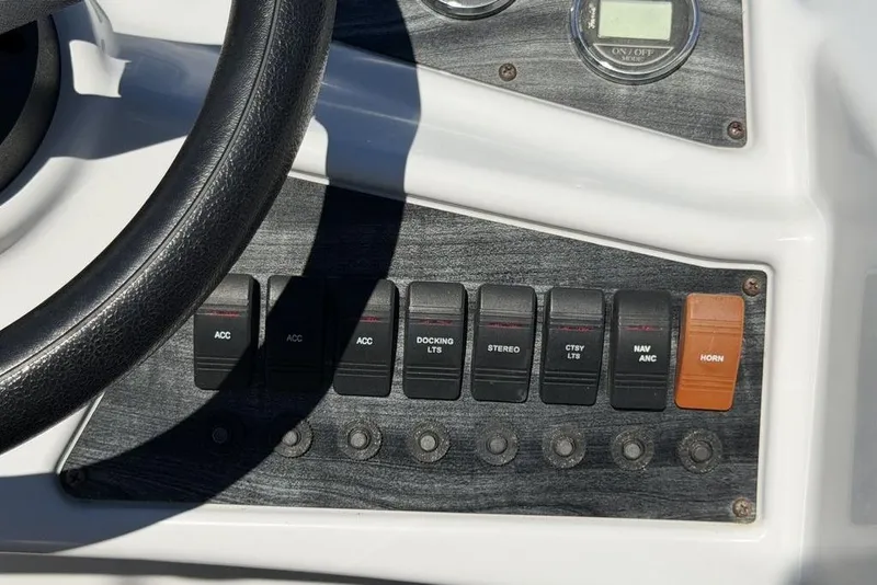 Slide: The Image of Control panel of 2018 Godfrey SWEETWATER 2286 SB boat with switches and steering wheel. - 14